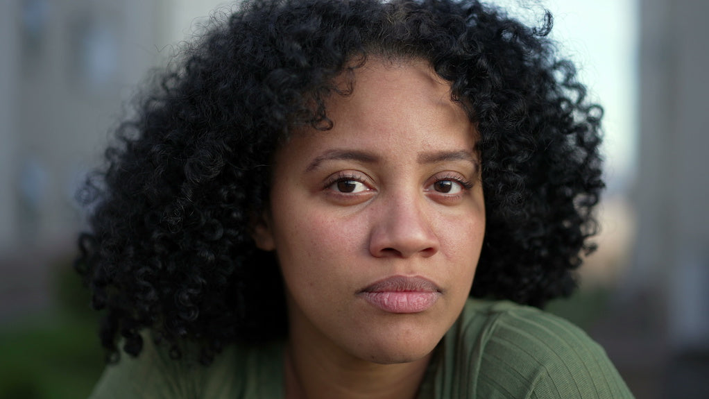 Autism assessment like for adults: close up portrait photo of a woman looking intently at the camera