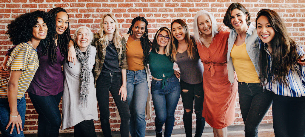 Diversity branded merchandise: a group of diverse women are standing in a line smiling.