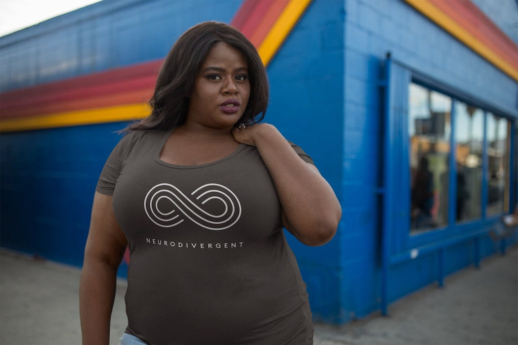 Gifts for autistic adults: a Black woman is wearing a t-shirt with the word neurodivergent printed on the front