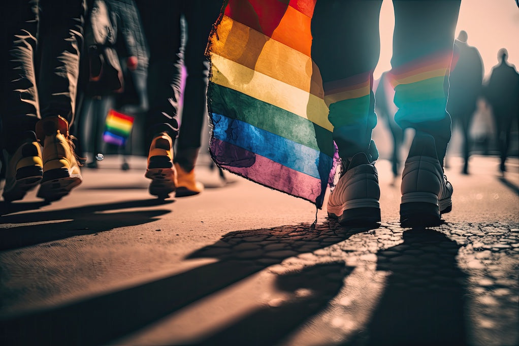 n AI generated image of the feet of people marching at Pride against the impact of anti-LGBTQ policies on public health in America