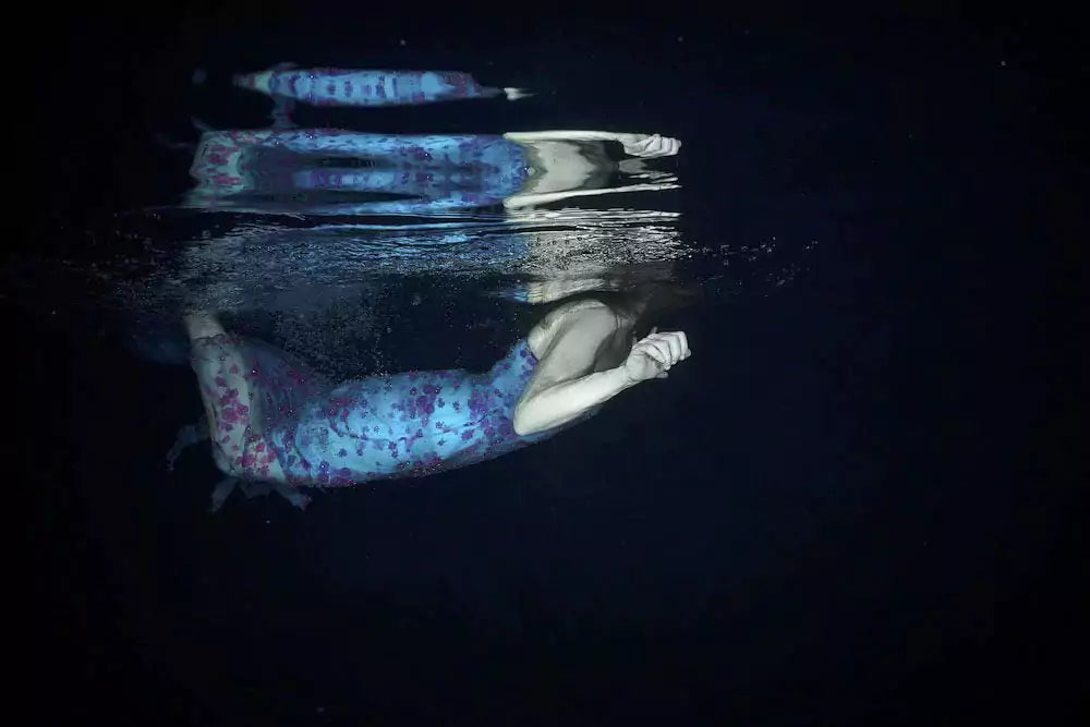 A person underwater, struggling to reach the surface, symbolizing depression.