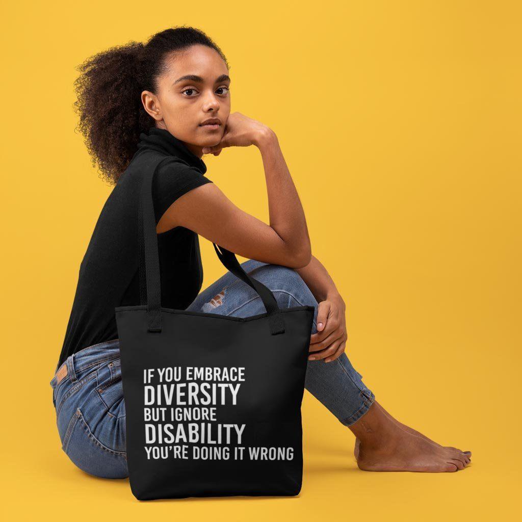 Diversity bags: a photo of a person and their 'embrace diversity' tote bag.