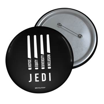 A photo of a JEDI pin by URevolution. In the middle of the black JEDI pin are four white lightsabers. At the bottom of each saber representing the saber handle is one word: Justice Equity Diversity Inclusion. Beneath the sabers is the acronym JEDI.