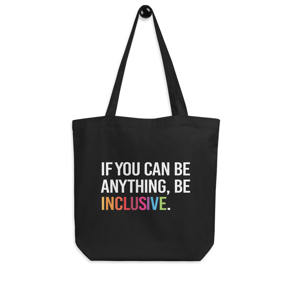 Picture of URevolution's eco-friendly organic Be Inclusive tote bag featuring our original phrase printed in white upper case letters: "If you can be anything, Be Inclusive." The word inclusive is in the colors of the rainbow. The phrase takes up three-quarters of the tote bag.  