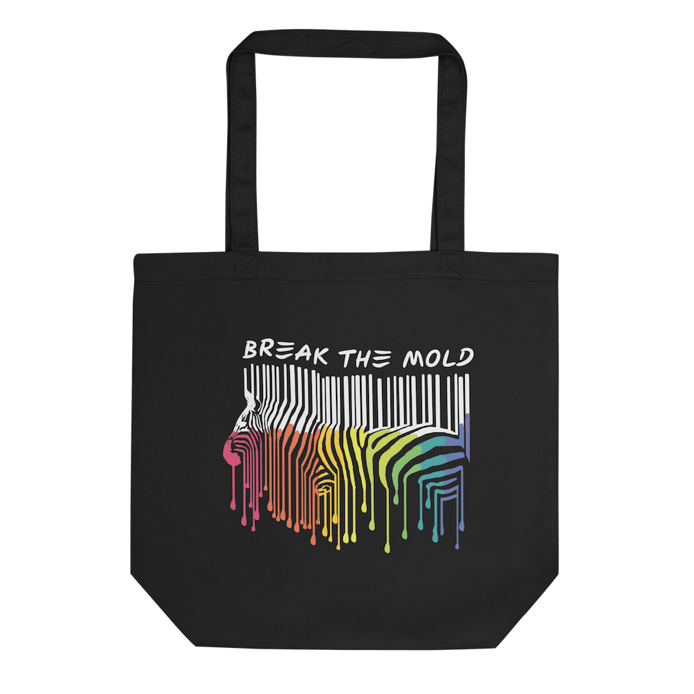 A photo of a black organic break the mold tote bag. In the middle of the break the mold tote is a graphic of zebra in the silhouette of a barcode. The top half of the zebra are vertical black stripes, which then change just below the back into the colors of the rainbow. The bottom of each stripe has a paint drip mark. Just above the zebra's back is the phrase, in upper case, 'break the mold.'