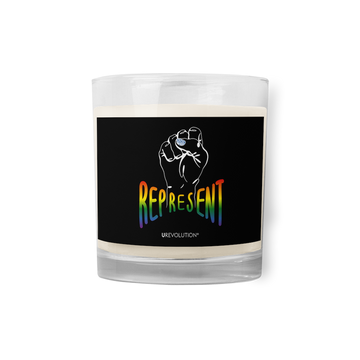 Photo of a black Represent candle. In the middle of the represent candle is a black sticker. On the sticker is a white line drawing of a raised clenched fist, with the handwritten word "represent," written in blended upper case rainbow pride colors: red, orange, yellow, green, indigo, and violet. Under the fist, at the bottom of the magnet, is the word URevolution in small white upper case letters.