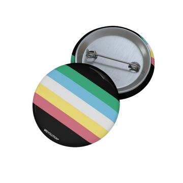 This is an image of a disability pride pin. In the middle of the pin is the disability pride flag: a dark grey-black background with five diagonal stripes in this order: red, yellow, white, blue, and green (when looking from the bottom up). 